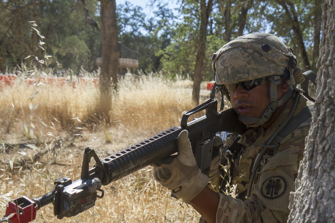 U.S. Army Spc. Jonathan Rosario, part of the Quick Reaction Force on Tactical Assembly Area (TAA) Schoonover, reacts to enemy fire during the 91st Training Division’s Warrior Exercise on Fort Hunter Liggett, Calif. June 14, 2017. The Quick Reaction Force is called when the Entry Control Point of a TAA is either compromised or threatened.