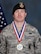 Staff Sgt. Brandan Holliday, 178th Security Forces Squadron, displays his first place medal he earned in the Ohio Police and Fire Games wrestling tournament in Canton Ohio June 14.
The Games offer more than 35 events to participants, with local first responders coordinating the events. (U.S. Air National Guard photo by Senior Master Sgt. Joseph Stahl)