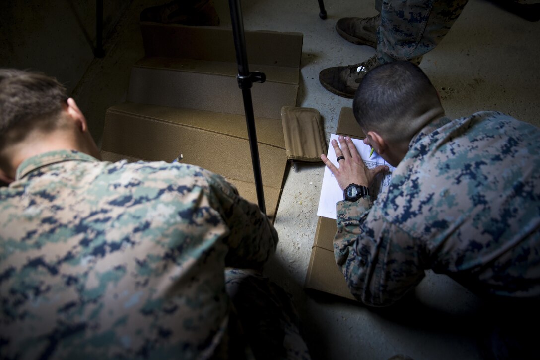 Marine Corps Lance Cpl. Hector Olmo Sanabria, right, a rifleman assigned to Marine Rotational Force Europe 17.1, fills out a range card during a precision-fire range near Stjørdal, Norway, June 6, 2017. The Marines were given 30 minutes to complete a sketch of the down-range area as part of their designated marksman training. Marine Corps photo by Cpl. Victoria Ross