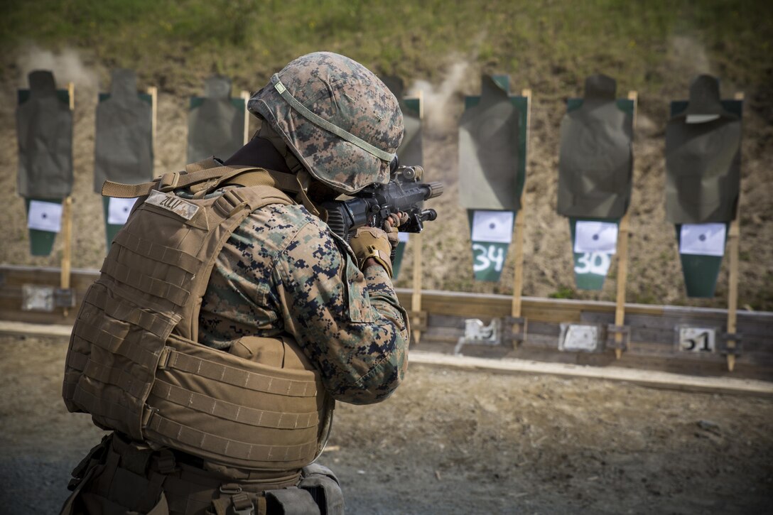 Marine Corps Lance Cpl. Teddy Zulu, a rifleman assigned to Marine Rotational Force Europe 17.1, moves from the 15 meter line to the five meter line during a combat marksmanship range near Stjørdal, Norway, June 7, 2017. Infantrymen fired from standing and kneeling positions and while moving toward the target during the course of fire. Marine Corps photo by Cpl. Victoria Ross