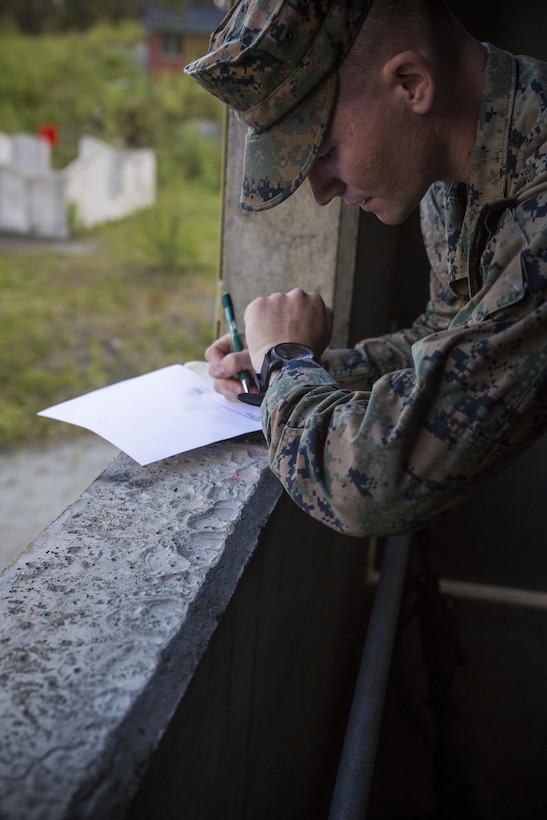 Marine Corps Lance Cpl. Mitchell Keppel, a rifleman assigned to Marine Rotational Force Europe 17.1, fills out a range card during a barricade range near Stjørdal, Norway, June 6, 2017. The Marines were given 30 minutes to complete a sketch of the down-range area as part of their designated marksman training. The Marines fired through windows at targets up to 500 meters away to maintain their urban proficiencies. Marine Corps photo by Cpl. Victoria Ross