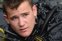 U.S. Army Pfc. Kyle Grimes, 74th Engineer Dive Detachment, 92nd Eng. Battalion second class diver, listens to instructions on inspecting Third Port’s piers during a diving mission at Joint Base Langley-Eustis, Va., June 20, 2017. Although the divers only swam down a maximum of 30 feet, the team can operate in water 190 feet below the surface. (U.S. Air Force photo/Airman 1st Class Kaylee Dubois)