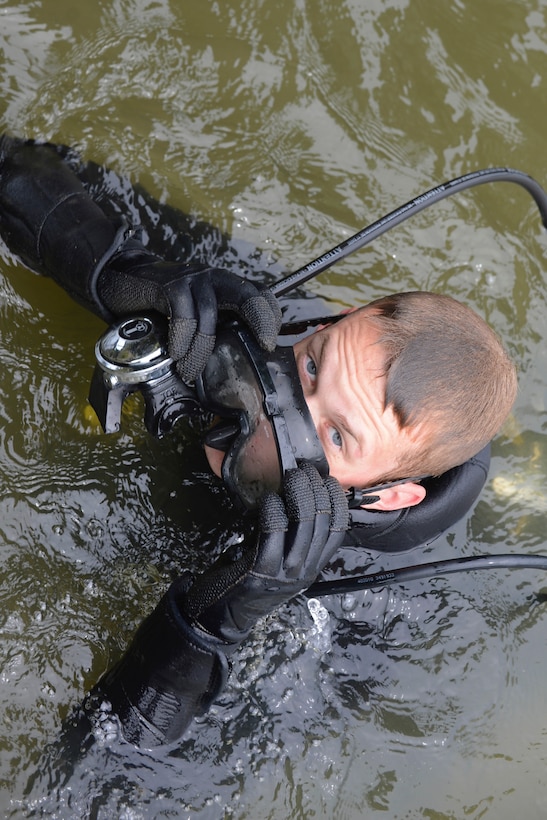 U.S. Army Pfc. Samuel Ladd, 74th Engineer Dive Detachment, 92nd Eng. Battalion second class diver, readjusts his scuba mask during a diving mission at Third Port at Joint Base Langley-Eustis, Va., June 20, 2017. The dive detachment is a crucial part of keeping Third Port, the Army’s only operational pier for deployment readiness, afloat and functioning for all transportation needs and training capabilities. (U.S. Air Force photo/Airman 1st Class Kaylee Dubois)