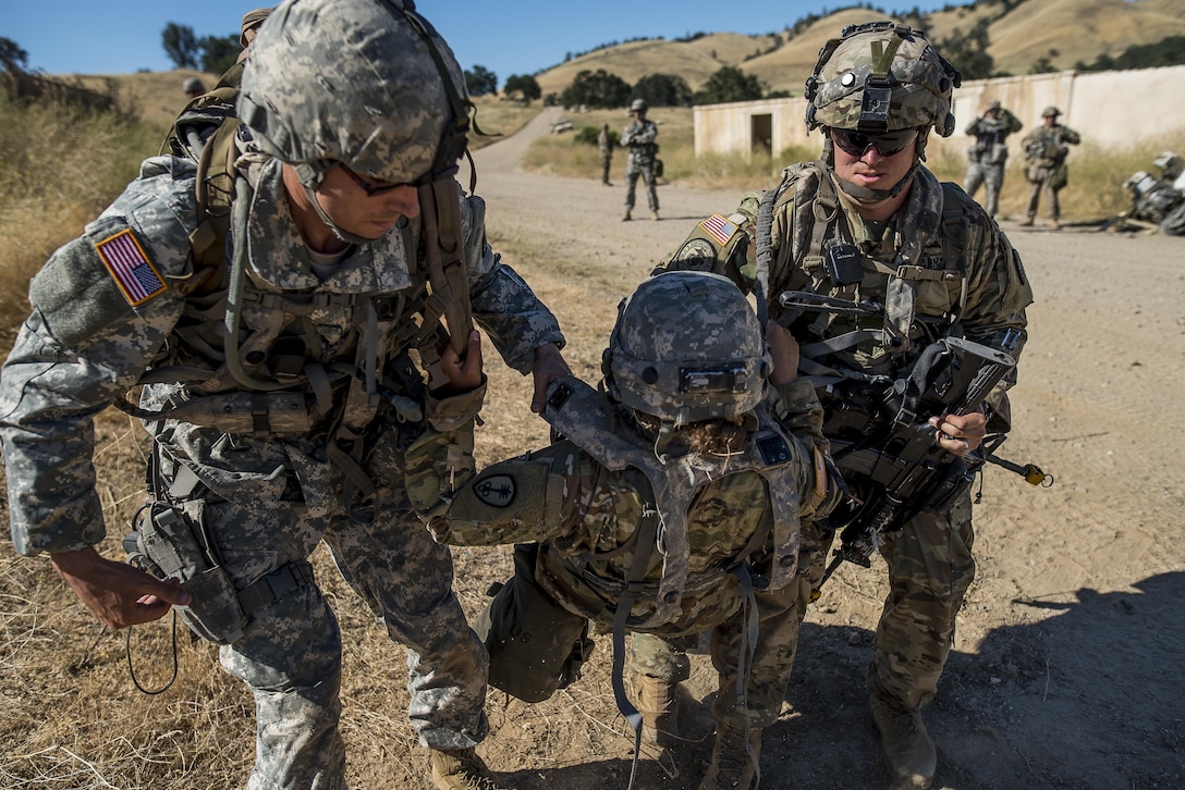 U.S. Army Reserve Soldiers from the 339th Military Police Company (Combat Support), headquartered in Davenport, Iowa, carry an "injured" battle-buddy to safety during a route reconnaissance training lane a Warrior Exercise (WAREX) held at Fort Hunter Liggett, California, June 19. The MP company's Soldiers had to relocate their tactical assembly areas in the field multiple times as they reconnoitered different areas of their operational environment, while fighting against temperatures reaching 100-plus degrees daily. (U.S. Army Reserve photo by Master Sgt. Michel Sauret)