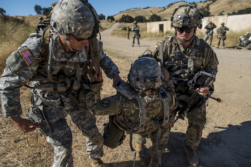 U.S. Army Reserve Soldiers from the 339th Military Police Company (Combat Support), headquartered in Davenport, Iowa, carry an "injured" battle-buddy to safety during a route reconnaissance training lane a Warrior Exercise (WAREX) held at Fort Hunter Liggett, California, June 19. The MP company's Soldiers had to relocate their tactical assembly areas in the field multiple times as they reconnoitered different areas of their operational environment, while fighting against temperatures reaching 100-plus degrees daily. (U.S. Army Reserve photo by Master Sgt. Michel Sauret)