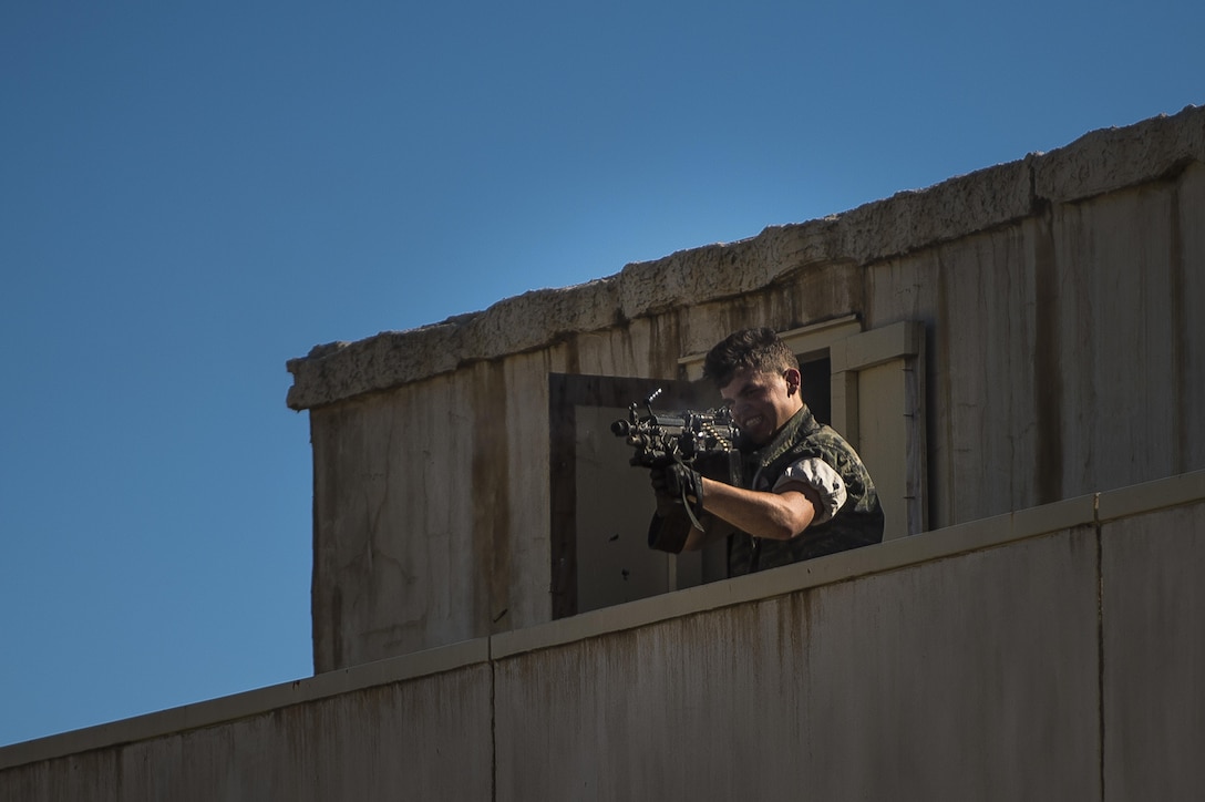 A member of opposition forces fires at U.S. Army Reserve Soldiers from the 339th Military Police Company (Combat Support), headquartered in Davenport, Iowa, during a route reconnaissance training event at a Warrior Exercise (WAREX) held at Fort Hunter Liggett, California, June 19. The MP company's Soldiers had to relocate their tactical assembly areas in the field multiple times as they reconnoitered different areas of their operational environment, while fighting against temperatures reaching 100-plus degrees daily. (U.S. Army Reserve photo by Master Sgt. Michel Sauret)