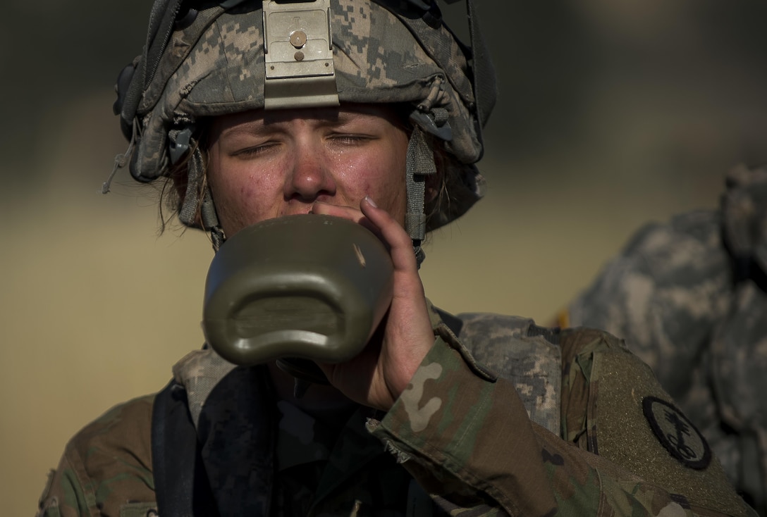Pfc. Caitlin Salefski, of Decatur, Illinois, a U.S. Army Reserve military police gunner for the 339th Military Police Company (Combat Support), headquartered in Davenport, Iowa, drinks water in the heat of a Warrior Exercise (WAREX) held at Fort Hunter Liggett, California, June 19. The MP company's Soldiers had to relocate their tactical assembly areas in the field multiple times as they reconnoitered different areas of their operational environment, while fighting against temperatures reaching 100-plus degrees daily. (U.S. Army Reserve photo by Master Sgt. Michel Sauret)