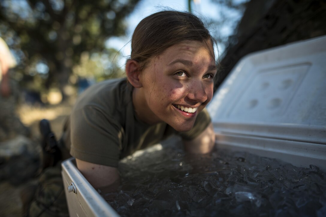 Pfc. Caitlin Salefski, of Decatur, Illinois, a U.S. Army Reserve military police gunner for the 339th Military Police Company (Combat Support), headquartered in Davenport, Iowa, dunks her arms in a cooler of ice in the heat of a Warrior Exercise (WAREX) held at Fort Hunter Liggett, California, June 19. The MP company's Soldiers had to relocate their tactical assembly areas in the field multiple times as they reconnoitered different areas of their operational environment, while fighting against temperatures reaching 100-plus degrees daily. (U.S. Army Reserve photo by Master Sgt. Michel Sauret)