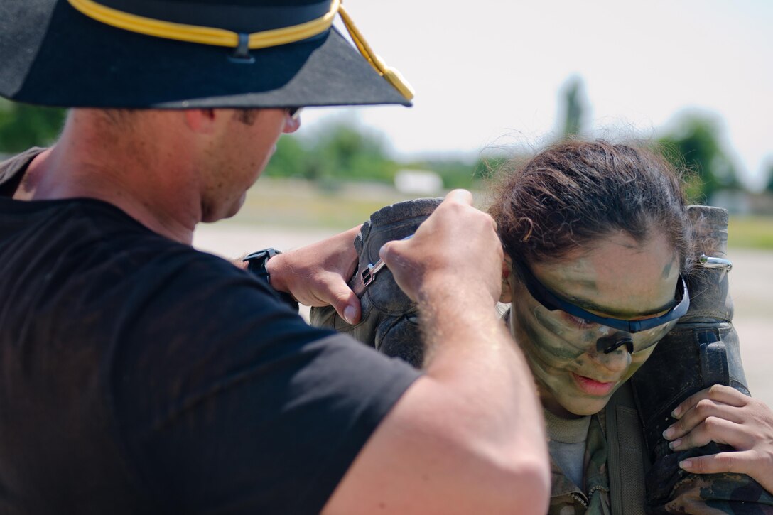 A soldier assigned to Apache Troop, 4th Squadron, 10th Cavalry Regiment supports a fellow soldier as he is awarded the silver spurs of the cavalry following a spur ride in Tata, Hungary, June 1, 2017.  Army photo by Capt. John W. Strickland