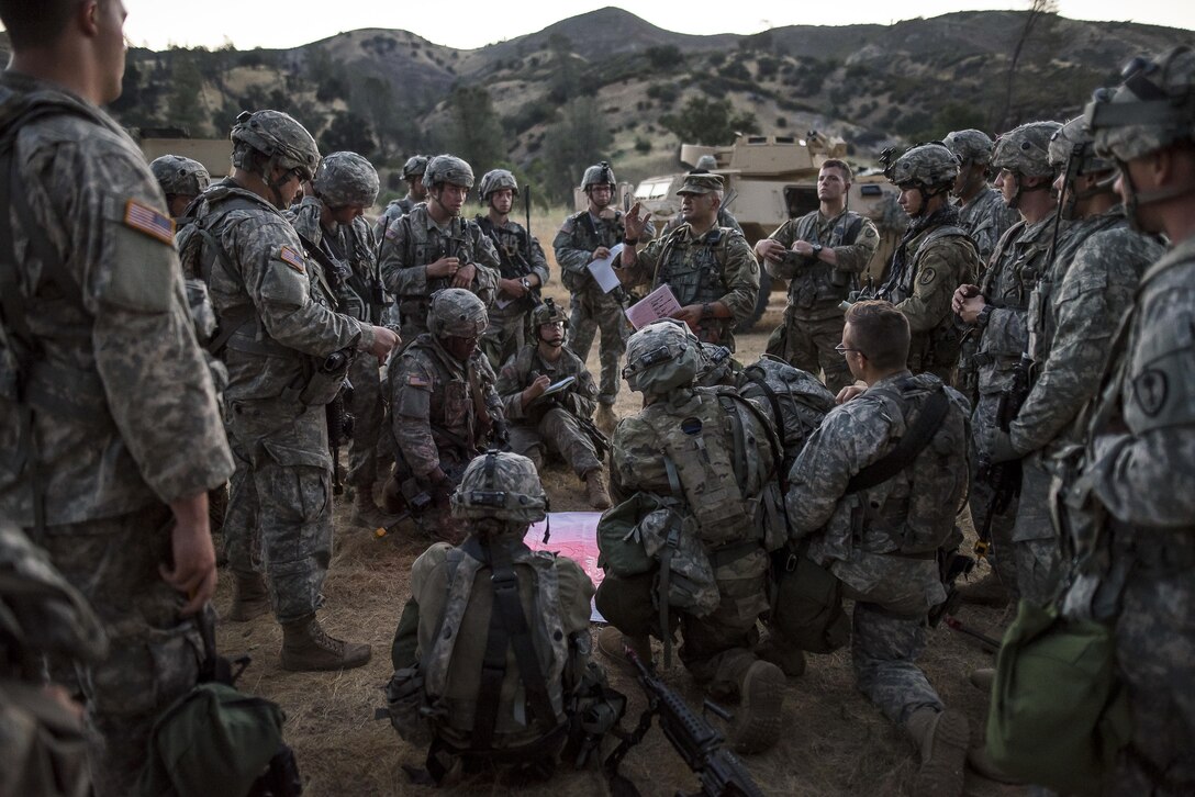 A platoon of U.S. Army Reserve Soldiers from the 339th Military Police Company (Combat Support), headquartered in Davenport, Iowa, conducts a convoy brief prior to a route reconnaissance mission at a Warrior Exercise (WAREX) held at Fort Hunter Liggett, California, June 20. The MP company's Soldiers had to relocate their tactical assembly areas in the field multiple times as they reconnoitered different areas of their operational environment, while fighting against temperatures reaching 100-plus degrees daily. (U.S. Army Reserve photo by Master Sgt. Michel Sauret)