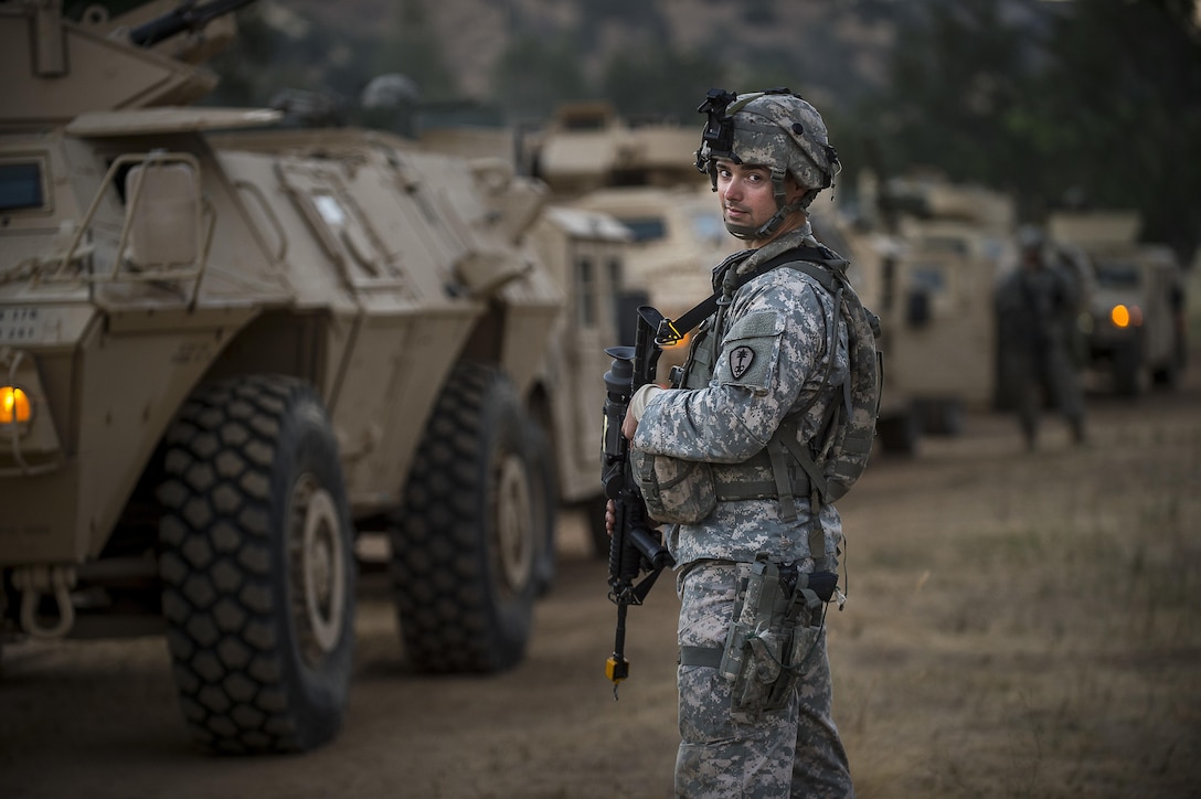 Cpl. Shawn Winchester, a U.S. Army Reserve military police Soldier from the 339th Military Police Company (Combat Support), headquartered in Davenport, Iowa, poses for a portrait before a route reconnaissance mission at a Warrior Exercise (WAREX) held at Fort Hunter Liggett, California, June 19. The MP company's Soldiers had to relocate their tactical assembly areas in the field multiple times as they reconnoitered different areas of their operational environment, while fighting against temperatures reaching 100-plus degrees daily. (U.S. Army Reserve photo by Master Sgt. Michel Sauret)