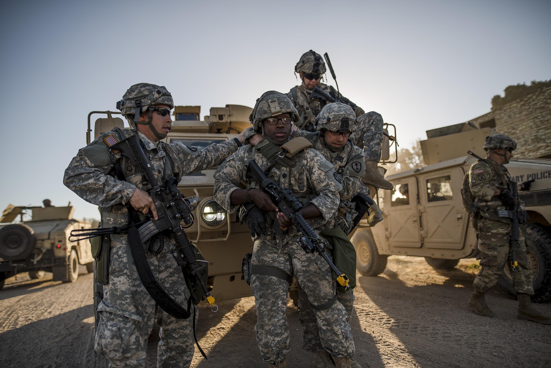 U.S. Army Reserve military police Soldiers from the 339th Military Police Company (Combat Support), headquartered in Davenport, Iowa, help evacuate an "injured" Soldier during a route reconnaissance at a Warrior Exercise (WAREX) held at Fort Hunter Liggett, California, June 20. The MP company's Soldiers had to relocate their tactical assembly areas in the field multiple times as they reconnoitered different areas of their operational environment, while fighting against temperatures reaching 100-plus degrees daily. (U.S. Army Reserve photo by Master Sgt. Michel Sauret)