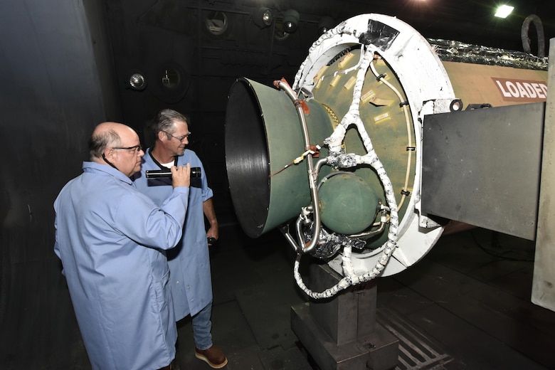 Members of the J-6 Large Rocket Motor Test Facility test team perform an inspection of the solid propellant rocket motor for the Minuteman III intercontinental ballistic missile prior to testing at the facility. (U.S. Air Force photo/Rick Goodfriend)