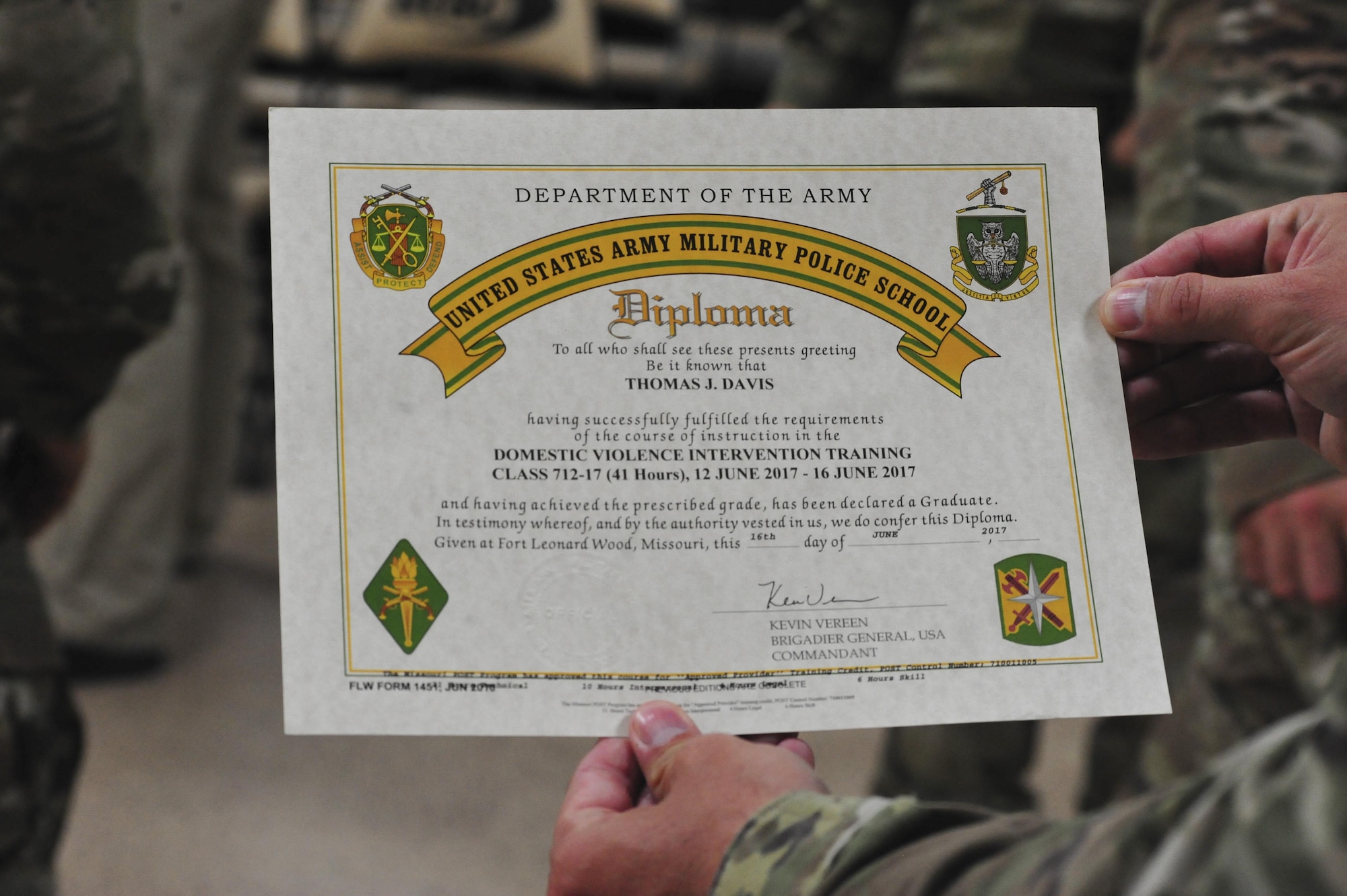 U.S. service members, law enforcement officers and patrolmen from the Joint Base Langley-Eustis, Va., and the Hampton Roads community receive certificates of completion at the end of the Domestic Violence Intervention Training course during a graduation ceremony at JBLE, Va., June 16, 2017. During the course, military and local law enforcement learned ways to be prepared for, understand, respond to and attempt to deescalate domestic violence situations. (U.S. Air Force photo/Angela D. Watson)
