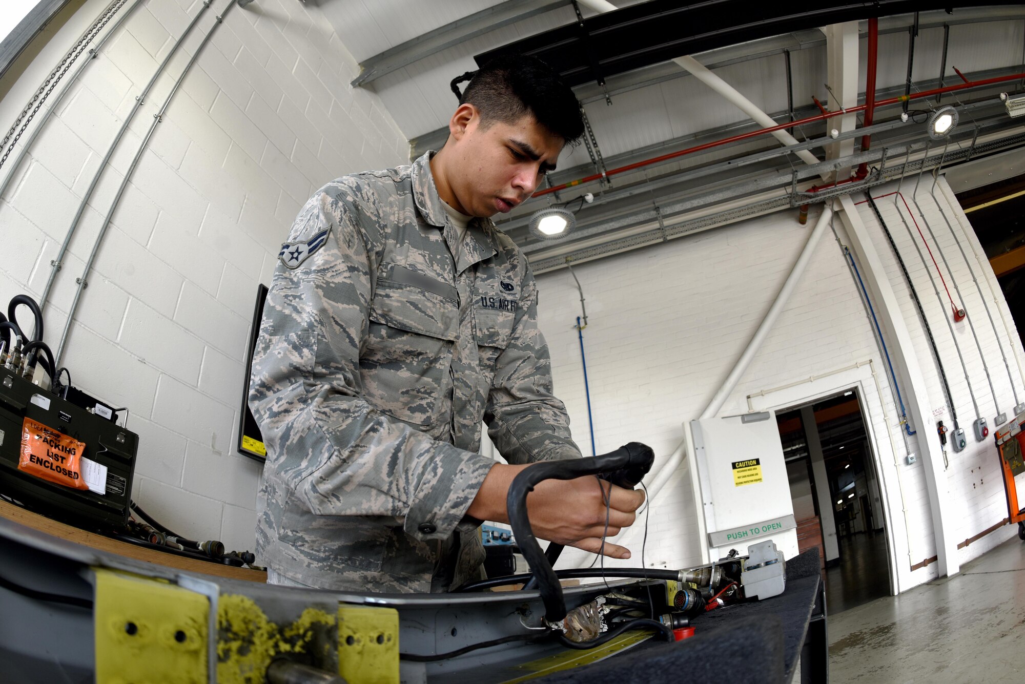 An aircraft armament specialist from the 48th Munitions Squadron tests for a wiring fault at Royal Air Force Lakenheath, England, June 13. Aircraft armament specialist test suspension, launch and release systems for retentive locking and manual or electrical release. (U.S. Air Force photo/Airman 1st Class John A. Crawford)