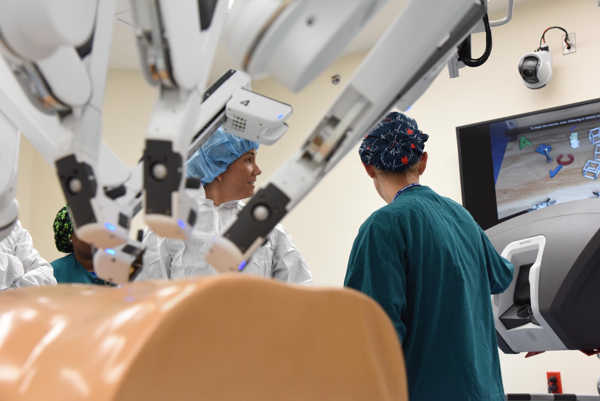 Col. Debra Lovette, 81st Training Wing commander, receives a briefing from 2nd Lt. Nina Hoskins, 81st Surgical Operations Squadron operating room nurse, on robotics surgery capabilities inside the robotics surgery clinic during an 81st Medical Group orientation tour in the Keesler Medical Center June 16, 2017, on Keesler Air Force Base, Miss. The purpose of the tour was to familiarize Lovette with the group’s mission, operations and personnel. (U.S. Air Force photo by Kemberly Groue) 