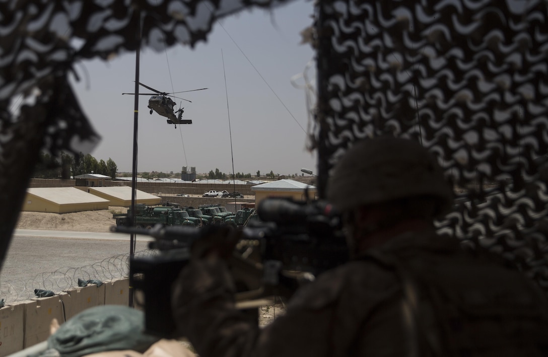 A U.S. Marine infantryman with Task Force Southwest posts security as a UH-60 Blackhawk lands at Bost Airfield, Afghanistan, June 18, 2017. Lt. Gen. William Beydler, the commanding general of Marine Corps Forces Central Command, met with key leaders from the provincial government, 505th Zone National Police and Afghan National Army 215th Corps, while receiving a first-hand look at the Task Force’s mission of training, advising and assisting their Afghan counterparts. (U.S. Marine Corps photo by Sgt. Justin T. Updegraff)