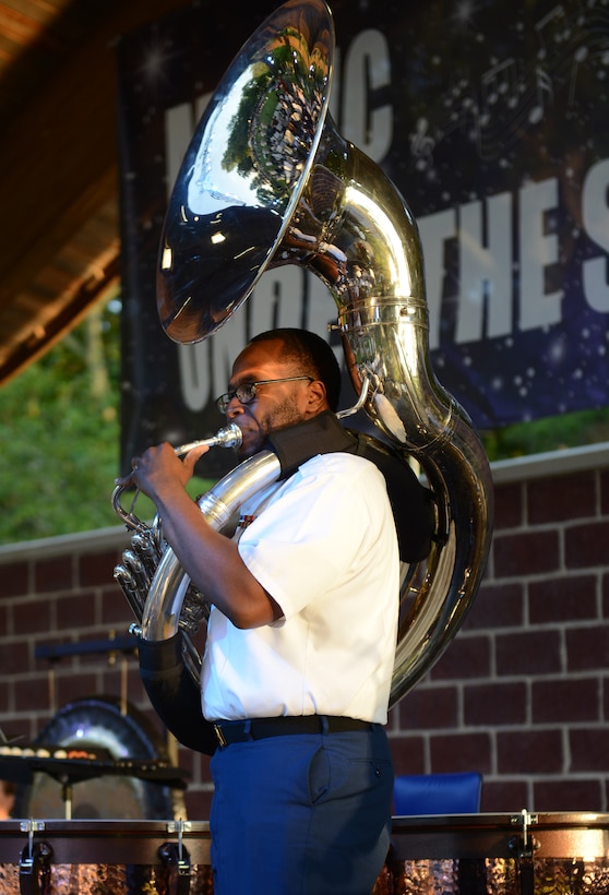 U.S. Army Spc. Geto Voltaire, Taining and Doctrine Command Band musician, plays the sousaphone during the Army’s 242nd birthday, Music Under the Stars event at Joint Base Langley-Eustis, Va., June 15, 2017. The band played various historical songs throughout the evening that highlighted significant events in Army history. (U.S. Air Force photo/Staff Sgt. Teresa J. Cleveland)