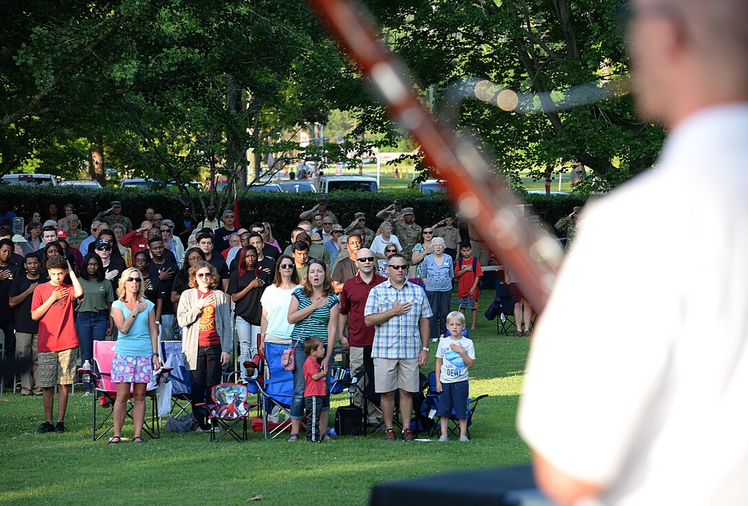 Audience members sing the national anthem during the Army 242nd birthday, Music Under the Stars celebration at Joint Base Langley-Eustis, Va., June 15, 2017. During the concert, U.S. Army Maj. General Bo Dyess, Army Capabilities Integration Center commander, administered the Oath of Enlistment to 35 Soldier recruits. (U.S. Air Force photo/Staff Sgt. Teresa J. Cleveland)