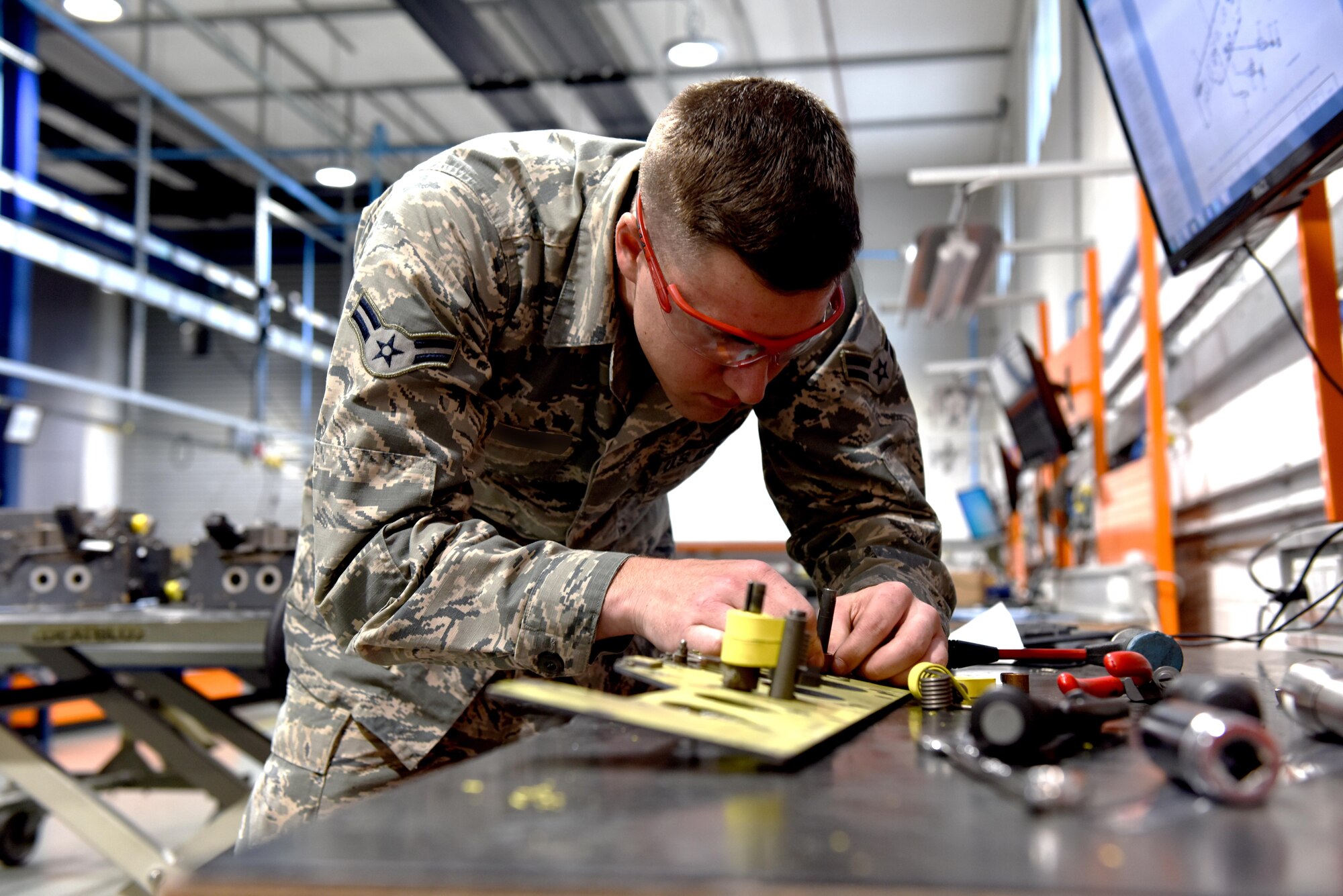 An aircraft armament specialist from the 48th Munitions Squadron repairs an interface panel at Royal Air Force Lakenheath, England, June 13. Aircraft armament specialists perform functional checks of launch and suspension systems. (U.S. Air Force photo/Airman 1st Class John A. Crawford)