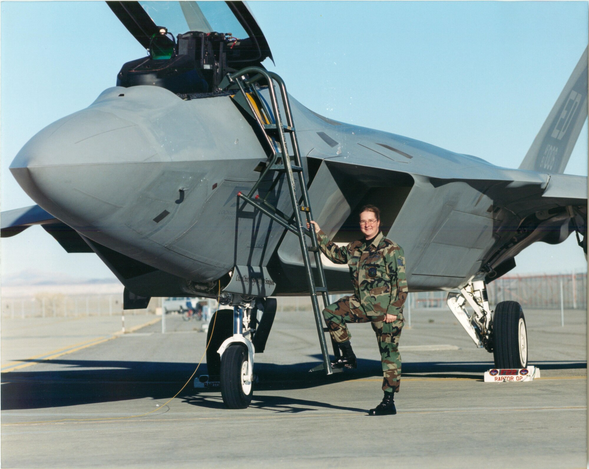 Carol Wagner is pictured as a young Airman in front of an F-22 Raptor. Wagner was the first female to be a dedicated crew chief for the F-22 at Tyndall Air Force Base, Fla. (Courtesy Photo) 