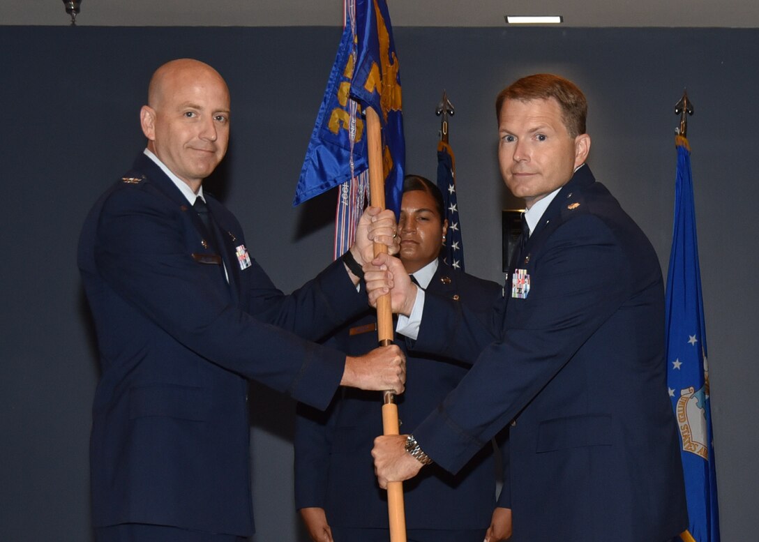 U.S. Air Force Col. Scott McKim, 325th Medical Group commander (left), presents the 325th Medical Operation Squadron guidon to the new commander, Maj. Dale Harrell, during the 325th MDOS change of command ceremony at Tyndall Air Force Base, Fla., June 19, 2017. The 325th MDOS mission is to provide medical and preventive health care to all wing and associated non-flying personnel and their dependents. (U.S. Air Force photo by Senior Airman Sergio A. Gamboa/Released)