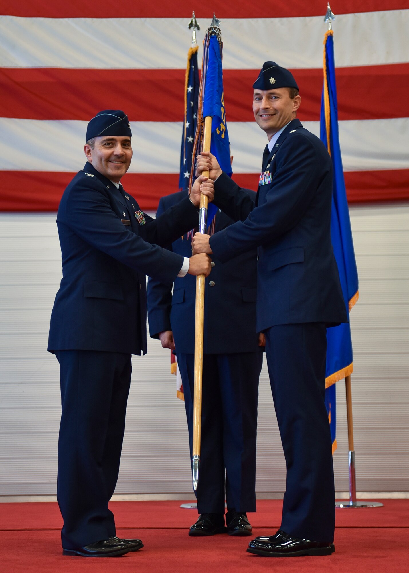 U.S. Air Force Col. Christian D. Kane, 325th Operations Group commander (left), presents the 325th Operations Support Squadron guidon to the new commander, Lt. Col. Tyler Ellison, during the 325th OSS change of command ceremony at Tyndall Air Force Base, Fla., June 20, 2017. The 325th OSS provides operational support for all of Team Tyndall and visiting units by managing the airfield, airspace, programmed flying training, wing flying hour program, flight records and weather support. (U.S. Air Force photo by Senior Airman Dustin Mullen/Released)