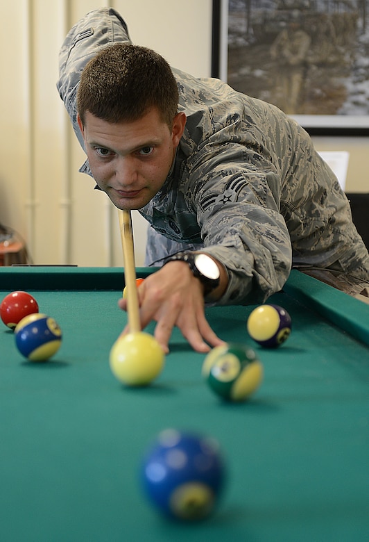 U.S. Air Force Senior Airman Logan, 45th Intelligence Squadron, plays a game of pool during a break from Airman Leadership School at a USO center at Joint Base Langley-Eustis, Va., June 19, 2017. The USO centers at JBLE and in the Hampton Roads community rely heavily on volunteer support to remain open and operational. (U.S. Air Force photo/Staff Sgt. Teresa J. Cleveland)
