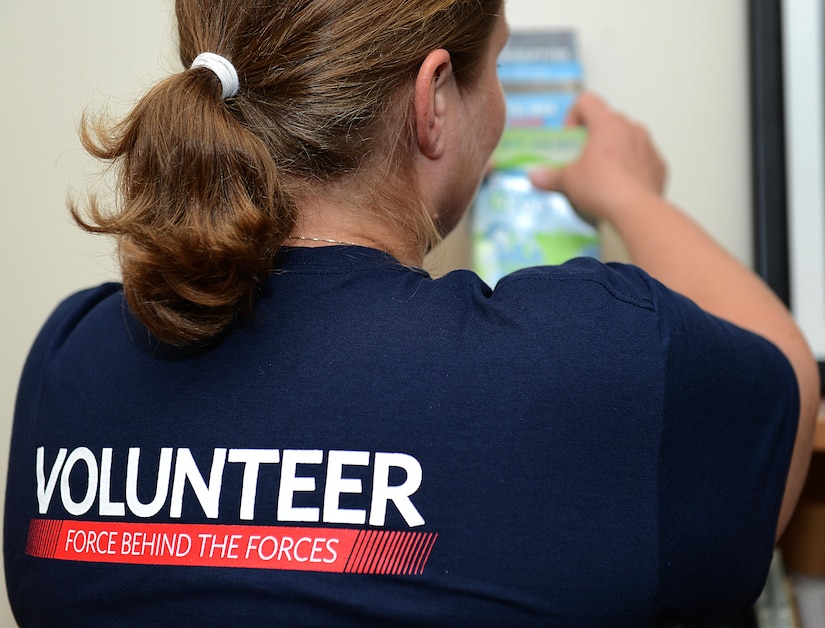 Kylie Wathen, a USO volunteer, organizes event calendars and brochures at a USO center at Joint Base Langley-Eustis, Va., June 19, 2017. As a military spouse, Wathen wanted to volunteer with the USO to give back to an organization which supports U.S. service members both at home and abroad.  (U.S. Air Force photo/Staff Sgt. Teresa J. Cleveland)