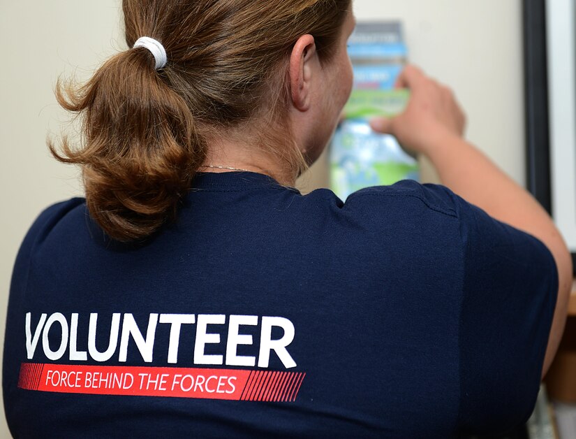 Kylie Wathen, a USO volunteer, organizes event calendars and brochures at a USO center at Joint Base Langley-Eustis, Va., June 19, 2017. As a military spouse, Wathen wanted to volunteer with the USO to give back to an organization which supports U.S. service members both at home and abroad.  (U.S. Air Force photo/Staff Sgt. Teresa J. Cleveland)