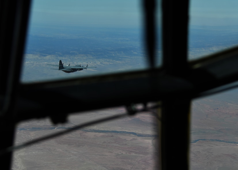 A C-130 Hercules aircraft flies across the Nevada desert on its way to participate in the Joint Forcible Entry exercise outside of Nellis Air Force Base, Nevada, June 10, 2017. During the JFE Vul Exercise, more than 100 aircraft and their crews worked together in a simulated contested degraded environment to train as a large formation in an enemy environment. (U.S. Air Force photo by Staff Sgt. Miles Wilson)