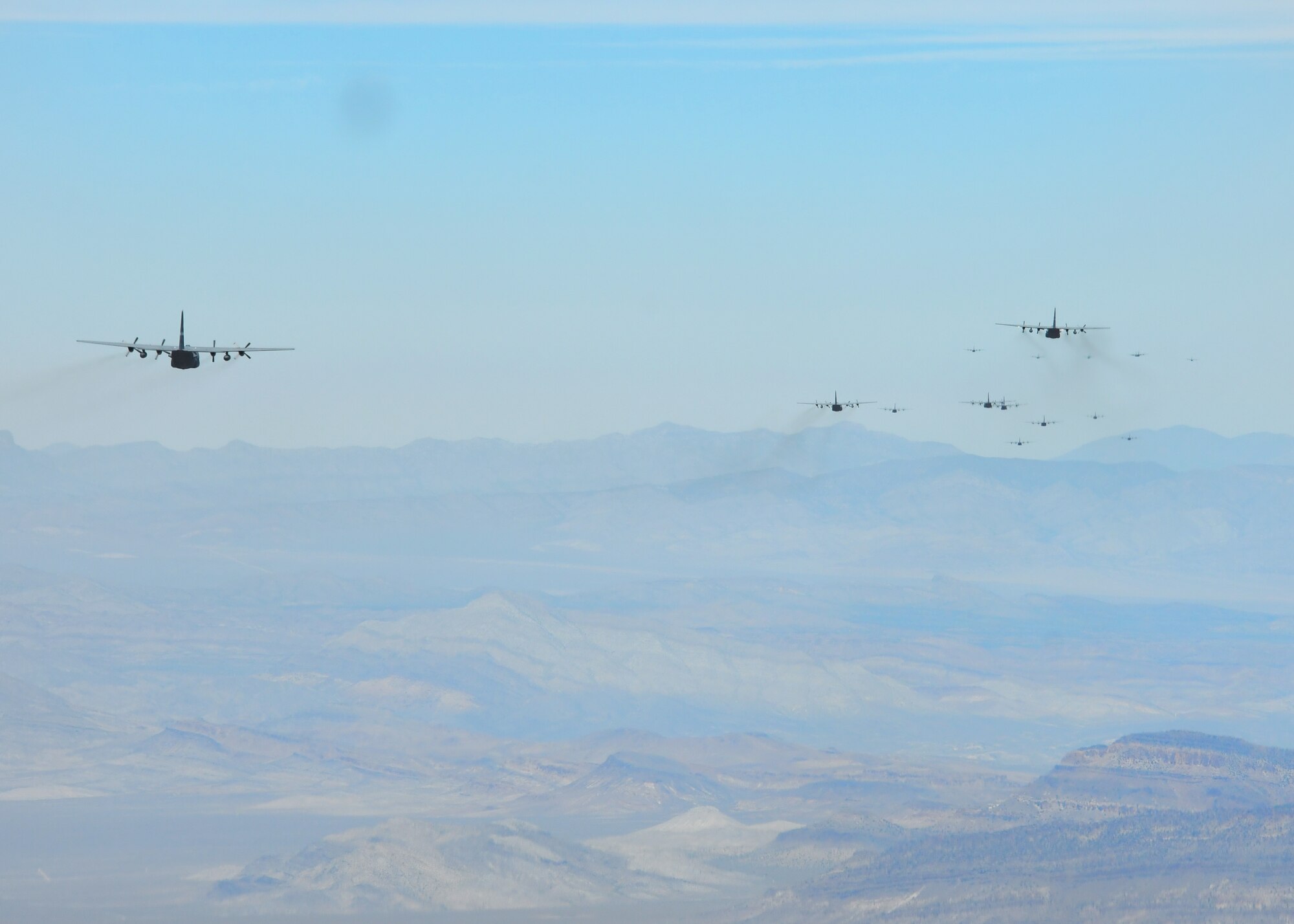 A fleet of C-130 aircraft fly in formation to participate in an exercise outside of Nellis Air Force Base, Nevada, June 10, 2017. The Joint Forcible Entry exercise, known as JFE Vul, is hosted and led by students graduating from the United States Air Force Weapons School twice a year, and tested the ability for various units and aircraft platforms to work together in a contested degraded environment. (U.S. Air Force photo by Staff Sgt. Miles Wilson)