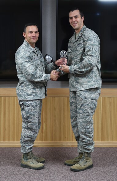 U.S. Air Force Col. David Benson (left), 7th Bomb Wing commander, presents the Air Force Global Strike Command Personnel Field Grade Officer of the Year Award to Maj. Donald Johnson (right), 7th Force Support Squadron operations officer, at Dyess Air Force Base, Texas, June 15, 2017. Nine individuals and programs were recognized at the U.S. Air Force and Air Force Global Strike Command levels for the year of 2016. (U.S. Air Force photo by Airman 1st Class Emily Copeland)