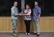 U.S. Air Force Col. David Benson (left), 7th Bomb Wing commander, presents the Air Force Global Strike Command Outstanding Education and Training Program Award to Jackie Vesey (center), 7th Force Support Squadron education services officer, and Adam Stirling (right), 7th FSS education specialist, at Dyess Air Force Base, Texas, June 15, 2017. Nine individuals and programs were recognized at the U.S. Air Force and Air Force Global Strike Command levels for the year of 2016. (U.S. Air Force photo by Airman 1st Class Emily Copeland)