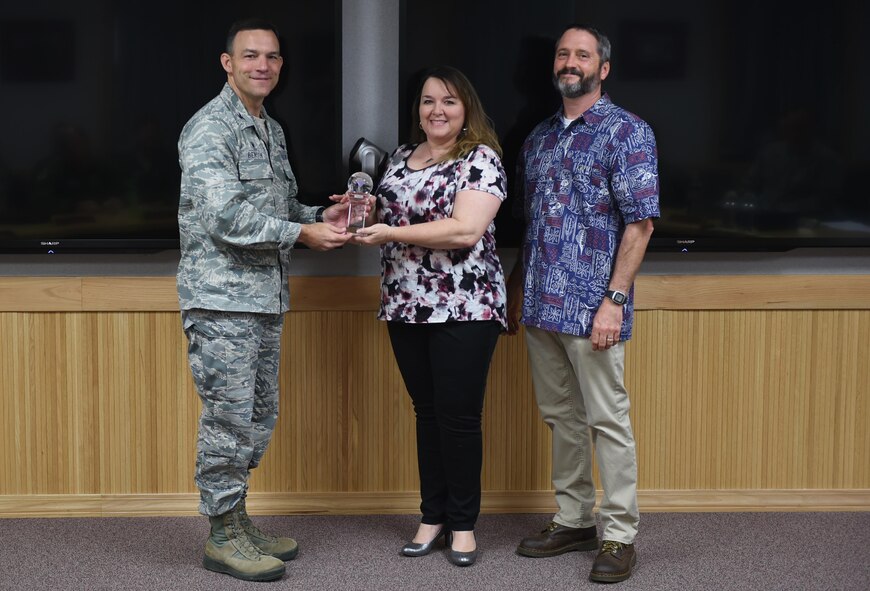 U.S. Air Force Col. David Benson (left), 7th Bomb Wing commander, presents the Air Force Global Strike Command Outstanding Education and Training Program Award to Jackie Vesey (center), 7th Force Support Squadron education services officer, and Adam Stirling (right), 7th FSS education specialist, at Dyess Air Force Base, Texas, June 15, 2017. Nine individuals and programs were recognized at the U.S. Air Force and Air Force Global Strike Command levels for the year of 2016. (U.S. Air Force photo by Airman 1st Class Emily Copeland)
