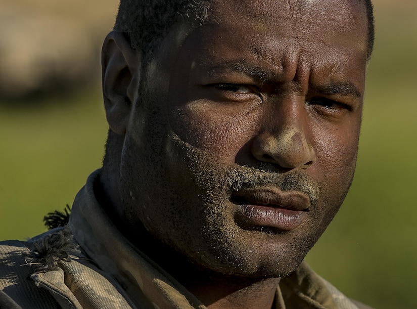 Pvt. Fabian Harper, of Moline, Illinois, a U.S. Army Reserve military police gunner from the 339th Military Police Company (Combat Support), headquartered in Davenport, Iowa, is covered in dust from a morning convoy operation at a Warrior Exercise (WAREX) held at Fort Hunter Liggett, California, June 20. The MP company's Soldiers had to relocate their tactical assembly areas in the field multiple times as they reconnoitered different areas of their operational environment, while fighting against temperatures reaching 100-plus degrees daily. (U.S. Army Reserve photo by Master Sgt. Michel Sauret)