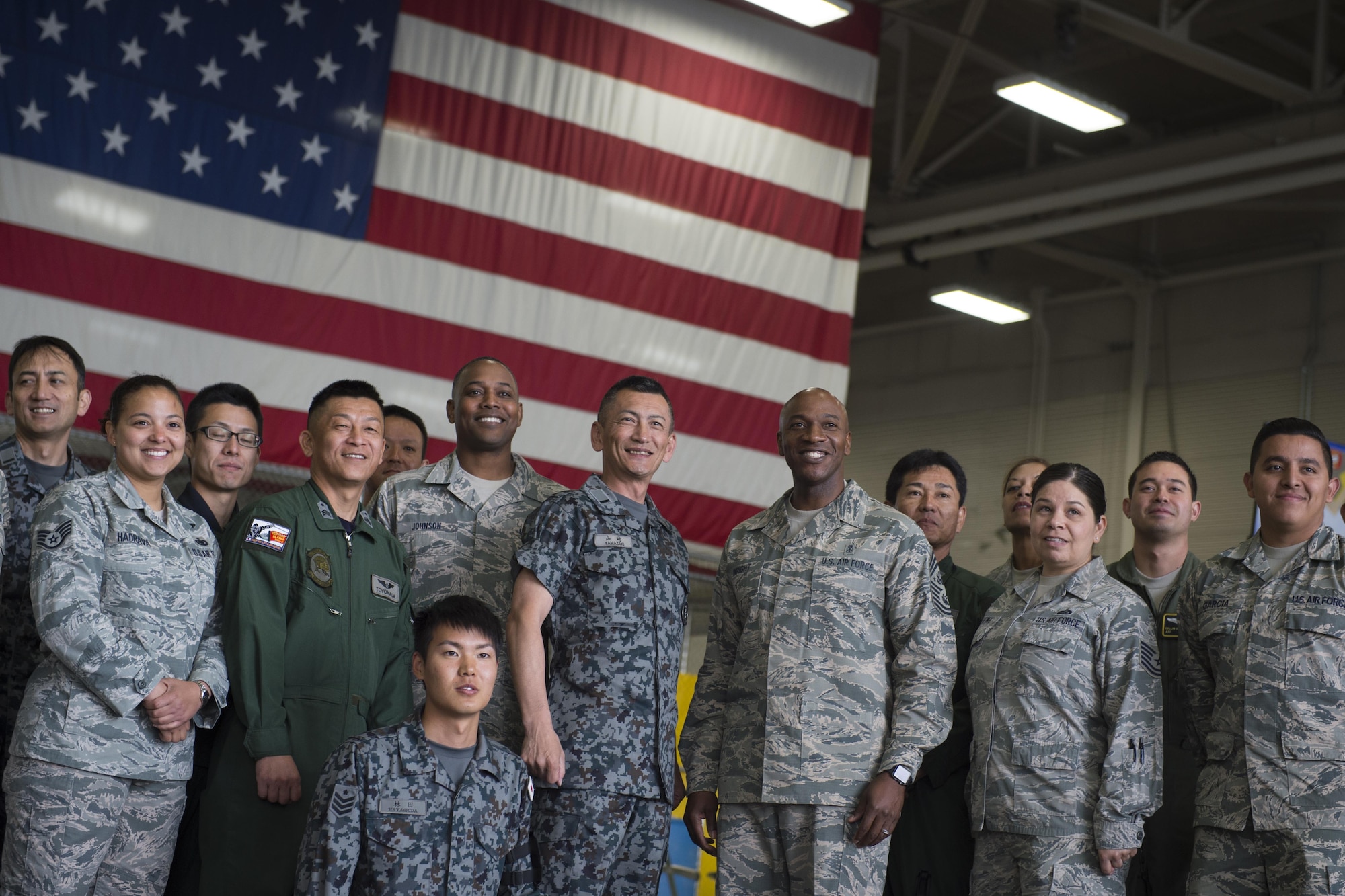 Warrant Officer Katsumi Yamazaki, senior enlisted advisor of the Japan Air Self-Defense Force and Chief Master Sgt. of the Air Force Kaleth O. Wright pose for a group photo at Joint Base Elmendorf-Richardson’s Hangar 4, June 19, 2017. The chief master sergeant of the Air Force, the Japan Air Self-Defense Force senior enlisted advisor, and other senior enlisted leaders visited Joint Base Elmendorf-Richardson, Alaska, as part of an international key-leader engagement. 