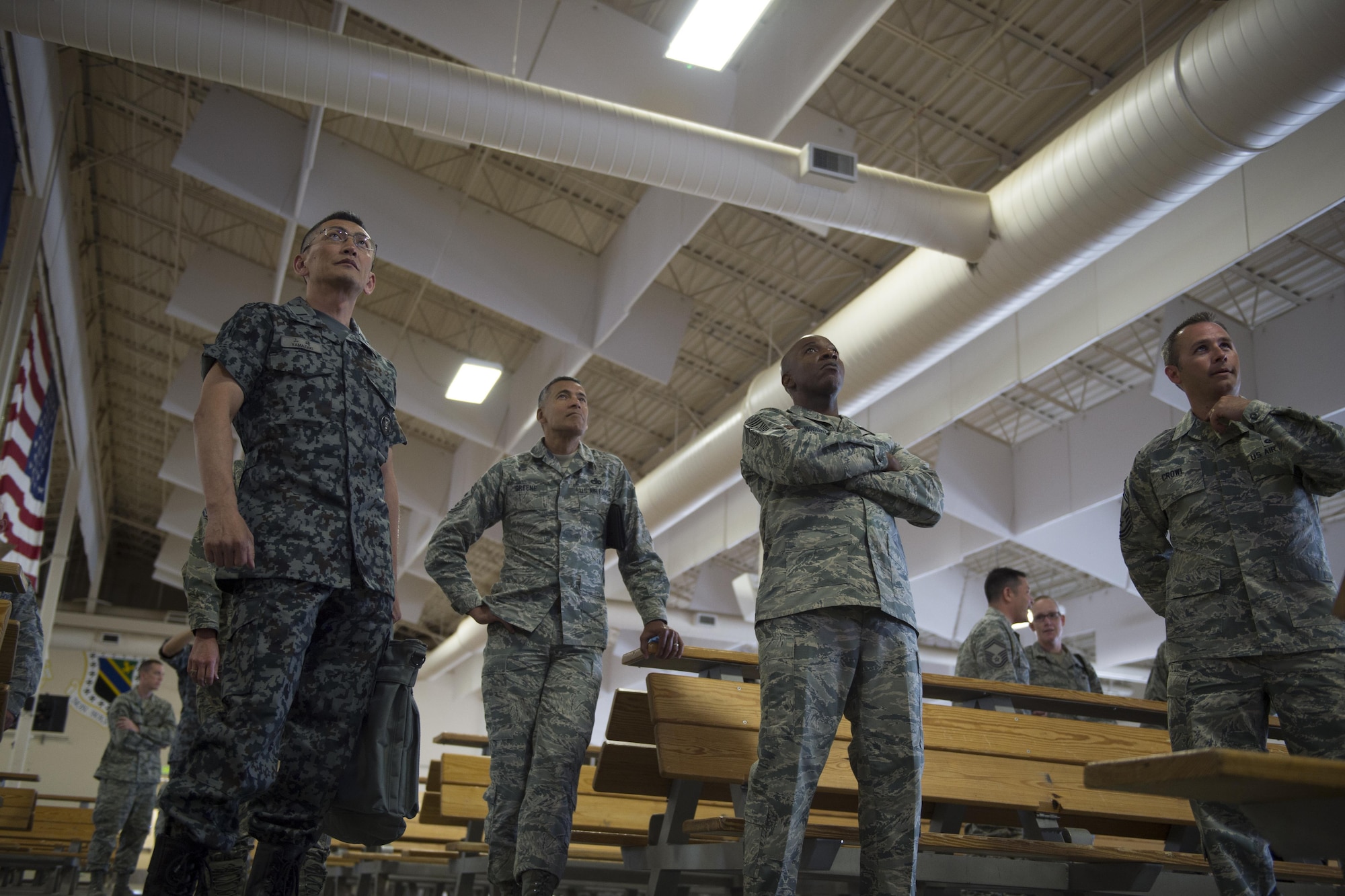 Warrant Officer Katsumi Yamazaki, senior enlisted advisor of the Japan Air Self-Defense Force, Chief Master Sgt. Terrence A. Greene, command chief master sergeant for U.S. Forces Japan, 5th Air Force, and Chief Master Sgt. of the Air Force Kaleth O. Wright, attentively listen to a Joint Mobility Complex mission presentation at Joint Base Elmendorf-Richardson, Alaska, June 19, 2017. The chief master sergeant of the Air Force, the Japan Air Self-Defense Force senior enlisted advisor, and other senior enlisted leaders visited Joint Base Elmendorf-Richardson, Alaska, as part of an international key-leader engagement. 