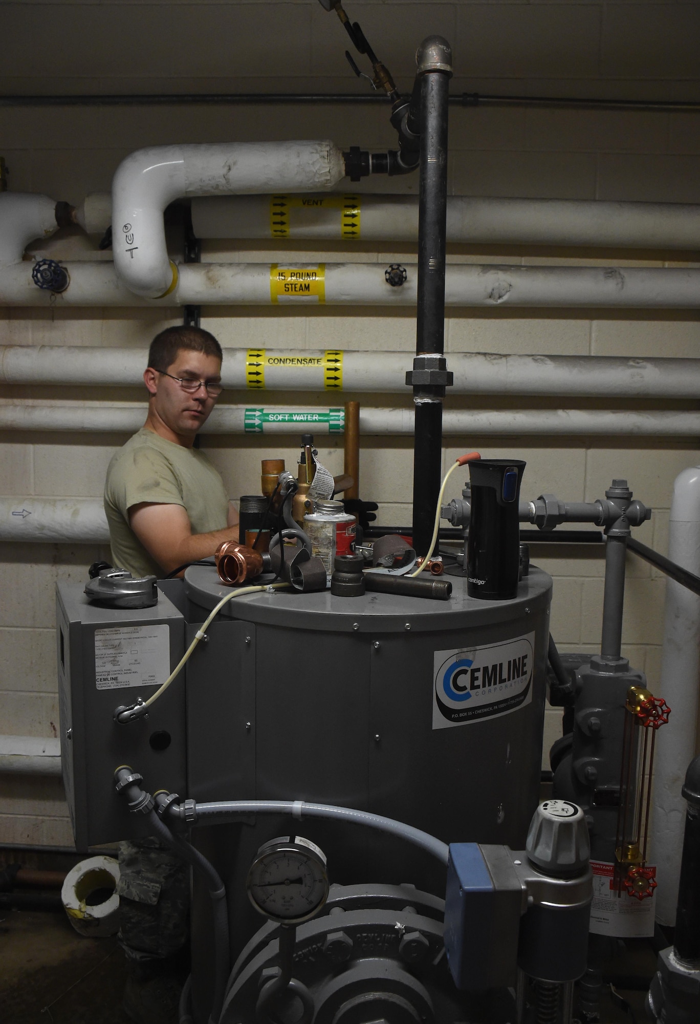 Airman Travis Yager, 446th Civil Engineer Squadron, installs a drain line for a boiler at Schriever Air Force Base, Colorado Thursday June 15, 2017. This was the first time Yager worked alongside the 50th Civil Engineer Squadron. (U.S. Air Force photo/Senior Airman Arielle Vasquez)