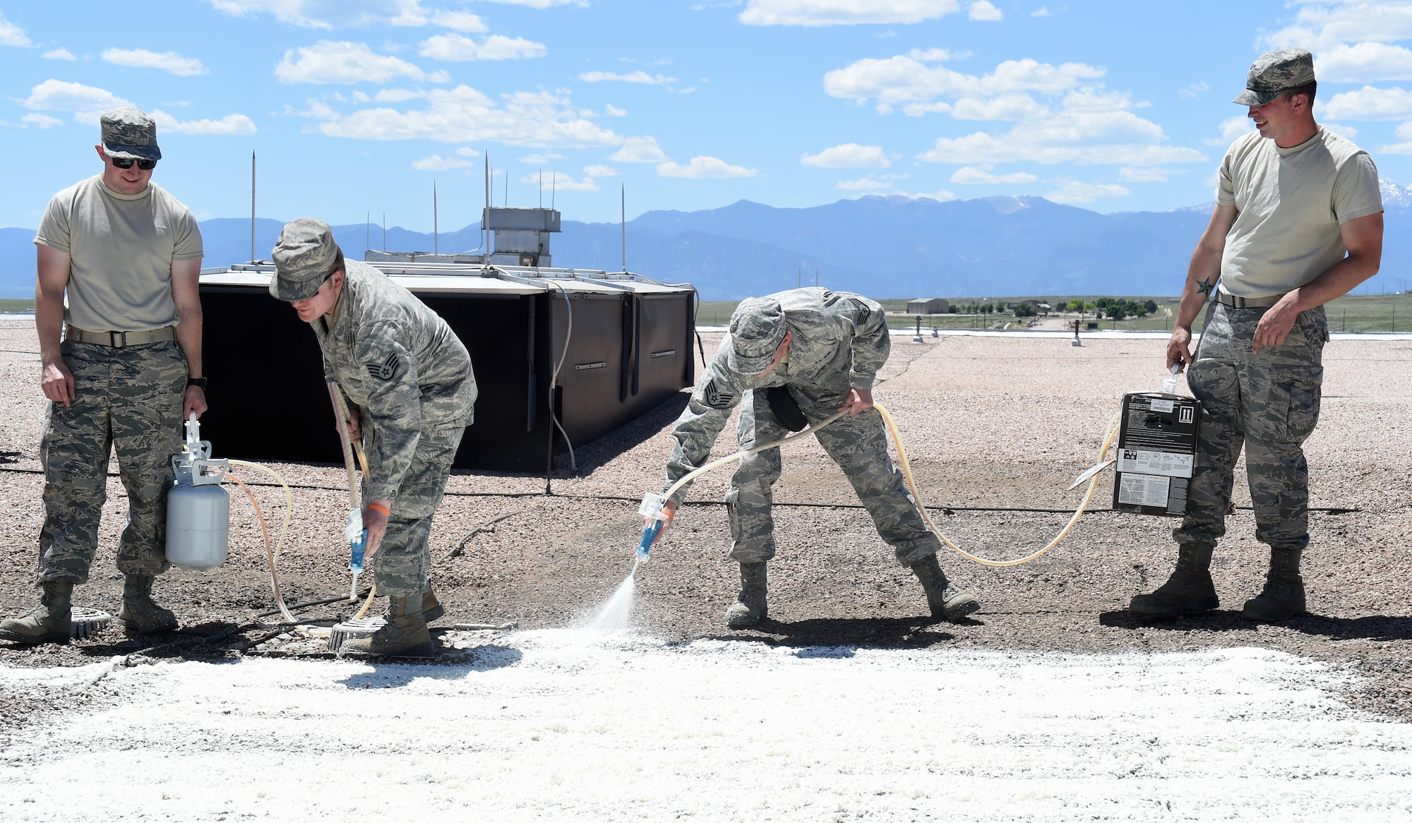 50th Civil Engineer Squadron members and 446th Civil Engineer Squadron reservists from Joint Base Lewis-McChord, Washington, use roofing foam to seal roof leaks at Schriever Air Force Base, Colorado Thursday June 15, 2017. The 446 CES reservists will be at Schriever until the end of the month to work alongside the 50 CES. (U.S. Air Force photo/Senior Airman Arielle Vasquez)