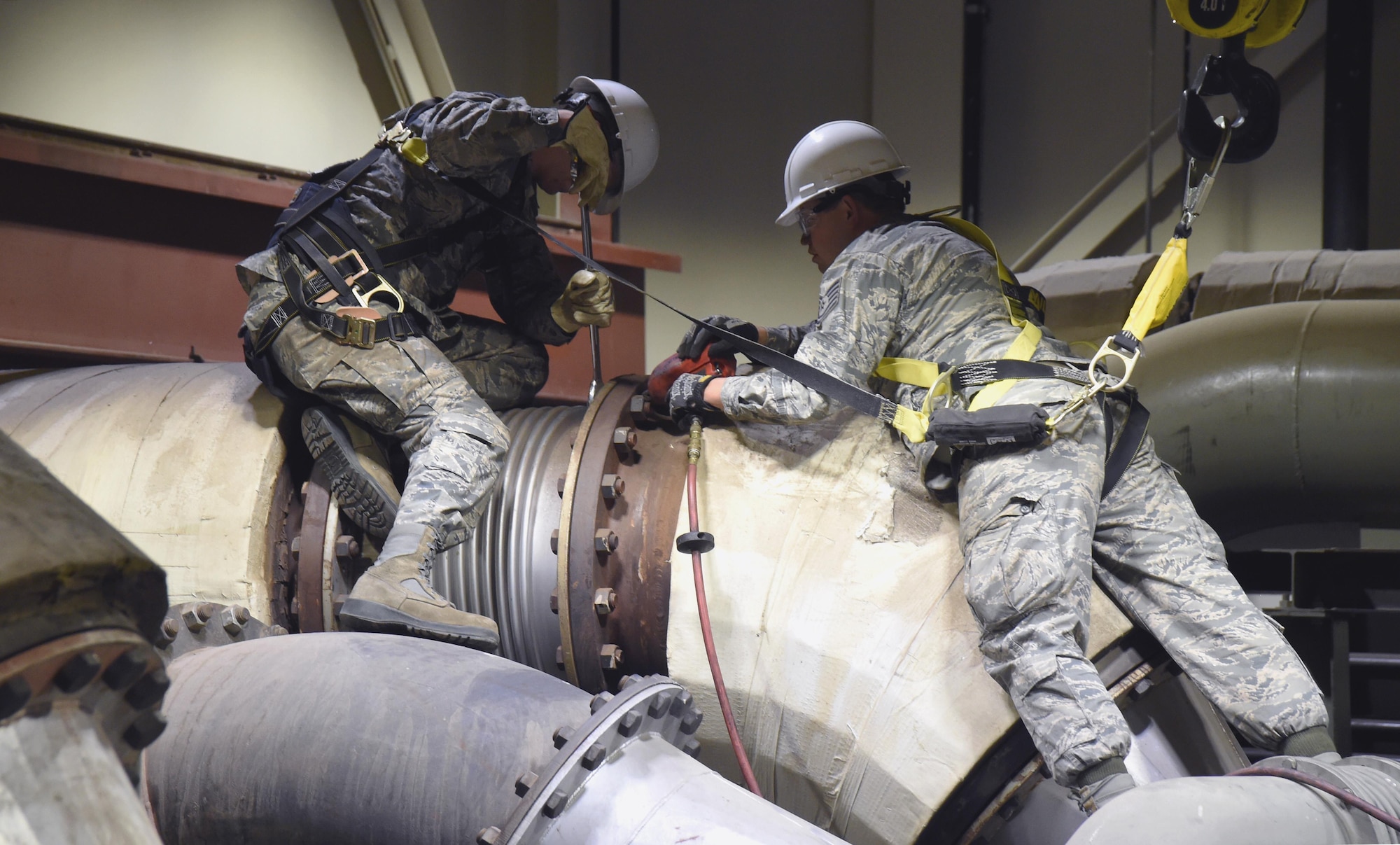 Tech. Sgt. Jon Vinson and Senior Airman Mason Conner with the 446th Civil Engineer Squadron from Joint Base Lewis-McChord, Washington, replace power production equipment at Schriever Air Force Base, Colorado Thursday June 15, 2017. For 446 CES Airmen, this has been an opportunity to become more proficient in their job and experience unique training opportunities. (U.S. Air Force photo/Senior Airman Arielle Vasquez)