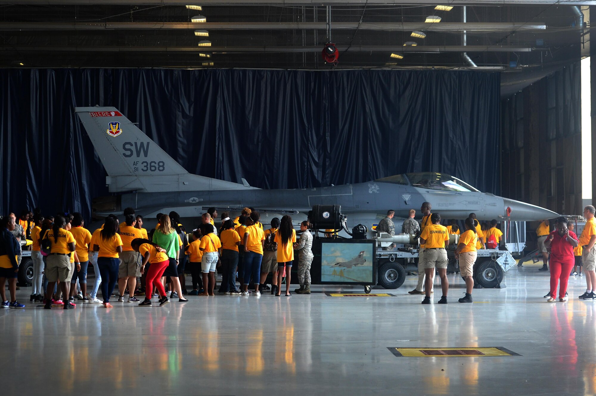 Attendees of the Sumter County Sheriff’s Office’s annual youth conference are briefed about the capabilities of the F-16CM Fighting Falcon at Shaw Air Force Base, S.C., June 16, 2017. During the conference, attendees safely interacted with a M61A1 Vulcan 20 mm rotary cannon, inert bombs and other 20th Fighter Wing weapons and equipment. (U.S. Air Force photo by Airman 1st Class Christopher Maldonado)