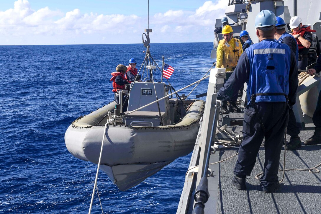Sailors lower a rigid-hull inflatable boat during a search and rescue drill aboard the guided missile destroyer USS Wayne E. Meyer in the Western Pacific Ocean, June 11, 2017. The Wayne E. Meyer is on a regularly scheduled Western Pacific deployment with the Carl Vinson Carrier Strike Group as part of the U.S. Pacific Fleet-led initiative to extend U.S. 3rd Fleet command and control functions into the Indo-Asia-Pacific region. Navy photo by Petty Officer 3rd Class Kelsey L. Adams