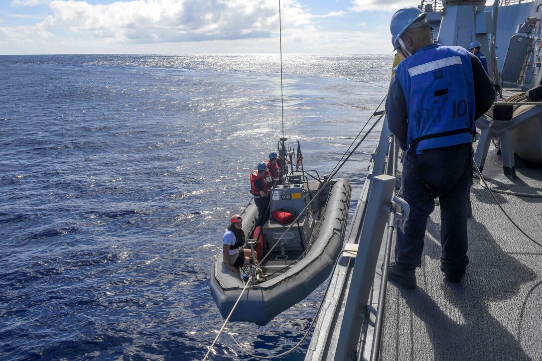 Sailors lower a rigid-hull inflatable boat during a search and rescue drill aboard the guided missile destroyer USS Wayne E. Meyer in the Western Pacific Ocean, June 11, 2017. Navy photo by Petty Officer 3rd Class Kelsey L. Adams