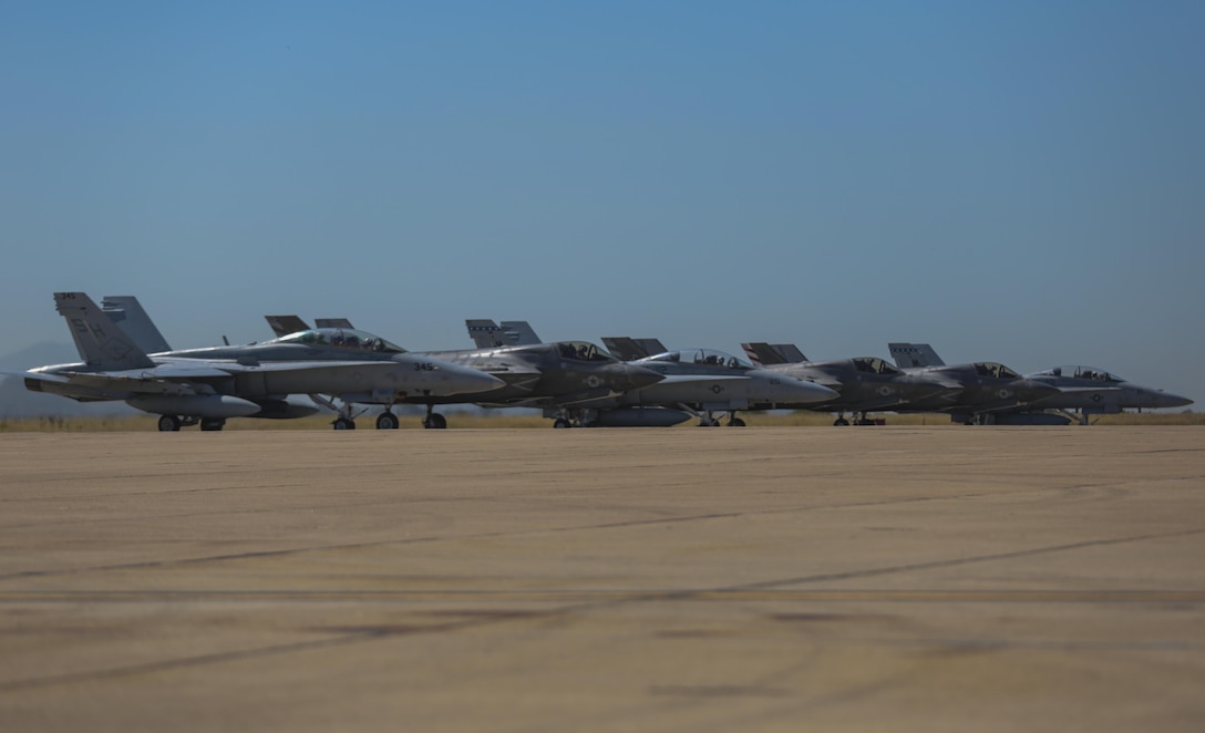 Three F-35B Lightning II and three F/A-18 Hornets line up before taking off during the Marine Division Tactics Course at Marine Corps Air Station Miramar, Calif., June 16. This course gives pilots air-to-air combat experience and the tools to train Marines in their squadrons on the latest tactics. (U.S. Marine Corps photo by Sgt. Kimberlyn Adams/Released)