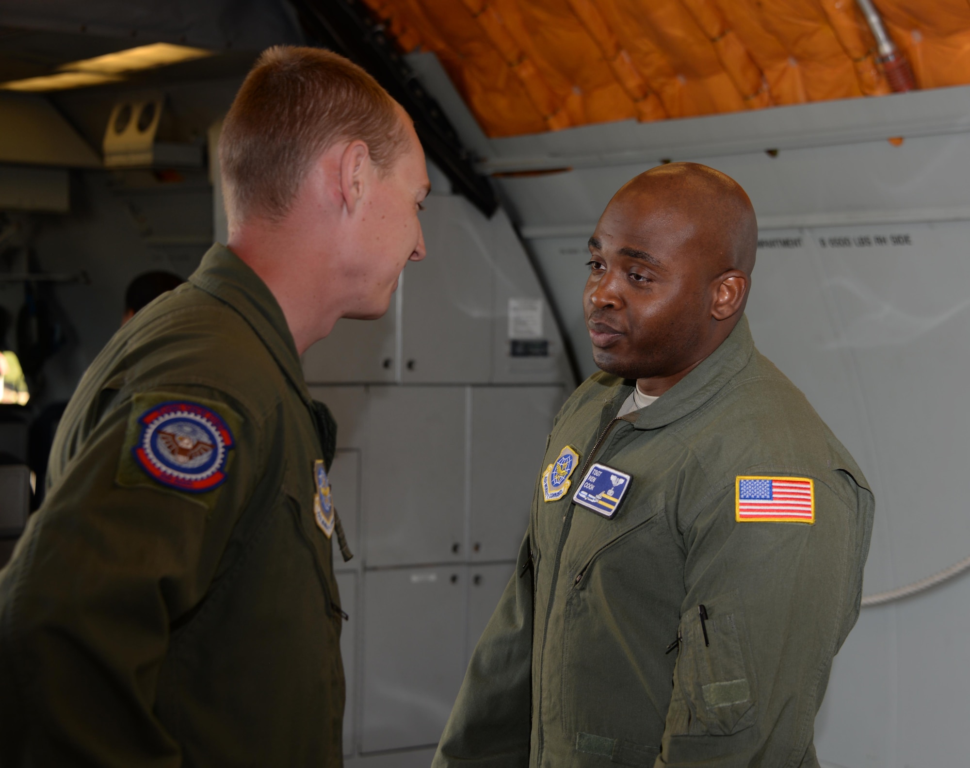 Staff Sgt. Jack McCoy (Left), 6th Air Refueling Squadron, chats with Tech. Sgt. Kenneth Cook (Right), 6th ARS, inside a KC-10 Extender prior to loading operations at Travis Air Force Base, Calif., June 17, 2017. Cook oversaw the loading of more than 15,000 pounds of cargo prior to a flight to Joint Base Pearl Harbor-Hickam, Hawaii. (U.S. Air Force photo/Tech. Sgt. James Hodgman)