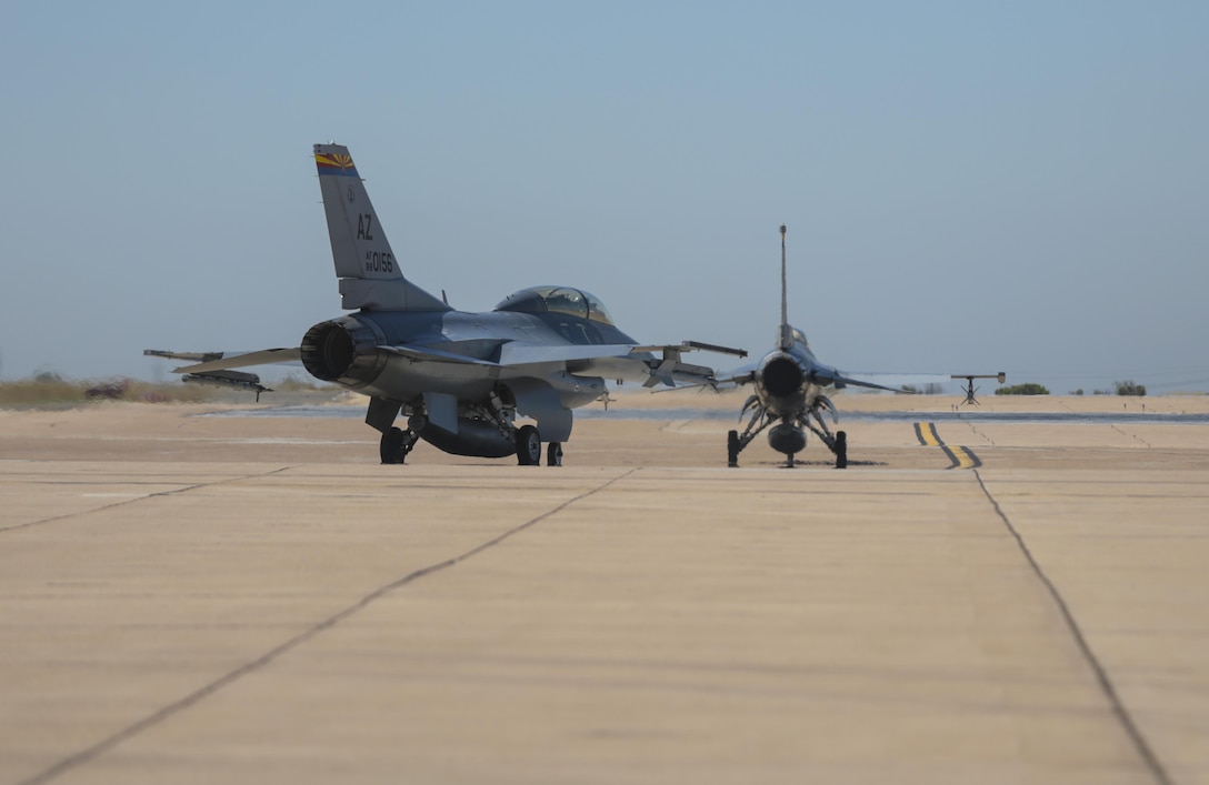 Two F-16 Fighting Falcons with the 21st Fighter Squadron out of Luke Air Force Base, Ariz., taxi to the runway during the Marine Division Tactics Course at Marine Corps Air Station Miramar, Calif., June 15. This course gives pilots air-to-air combat experience and the tools to train Marines in their squadrons on the latest tactics. (U.S. Marine Corps photo by Sgt. Kimberlyn Adams/Released)