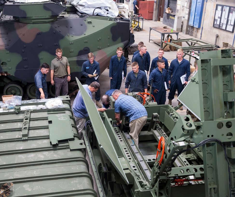 U.S. Marines and civilians work to install a MK-154 Launcher Mine Clearance kit onto an assault amphibious vehicle on Camp Pendleton, Calif., June 19, 2017. The MK-154 LMC is being reintroduced to the fleet after safety issues halted its employment in 2013. The system is the only amphibious breaching capability within the Department of Defense, allowing the forces assault mined areas.  (U. S. Marine Corps photo by Lance Cpl. Maritza Vela)