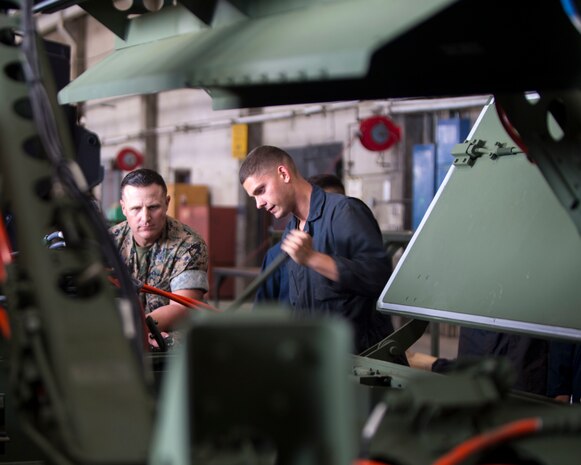 U.S. Marine Corps Pfc. Jacob Williams, student from Addison, New York, prepares a MK-154 Launcher Mine Clearance to be installed onto an assault amphibious vehicle on Camp Pendleton, Calif., June 19, 2017. The MK-154 LMC is being reintroduced to the fleet after safety issues halted its employment in 2013. The system is the only amphibious breaching capability within the Department of Defense, allowing the forces assault mined areas. (U. S. Marine Corps photo by Lance Cpl. Maritza Vela)