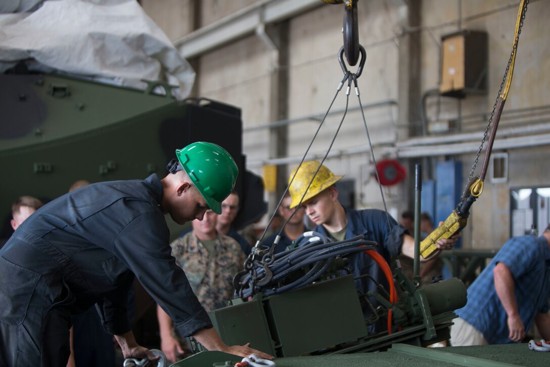 U.S. Marine Corps Pfc. Jacob Williams (left) and Lance Cpl. Alexander George (right), guide and Mk-154 Launcher Mine Clearance up to be placed on an assault amphibious vehicle on Camp Pendleton, Calif., June 19, 2017. The MK-154 LMC is being reintroduced to the fleet after safety issues halted its employment in 2013. The system is the only amphibious breaching capability within the Department of Defense, allowing the forces assault mined areas. (U. S. Marine Corps photo by Lance Cpl. Maritza Vela)